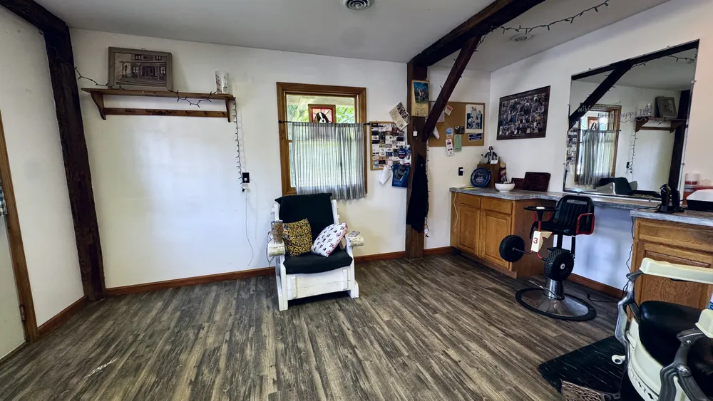 The kid-size barber chair with its steering wheel, next to the white rocker.